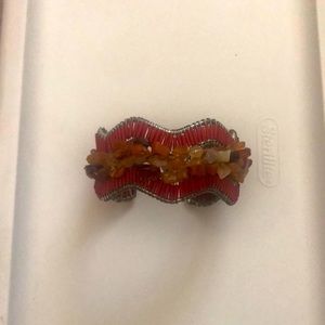 One size fits all bracelet. Earth tone stones trimmed with red and sliver